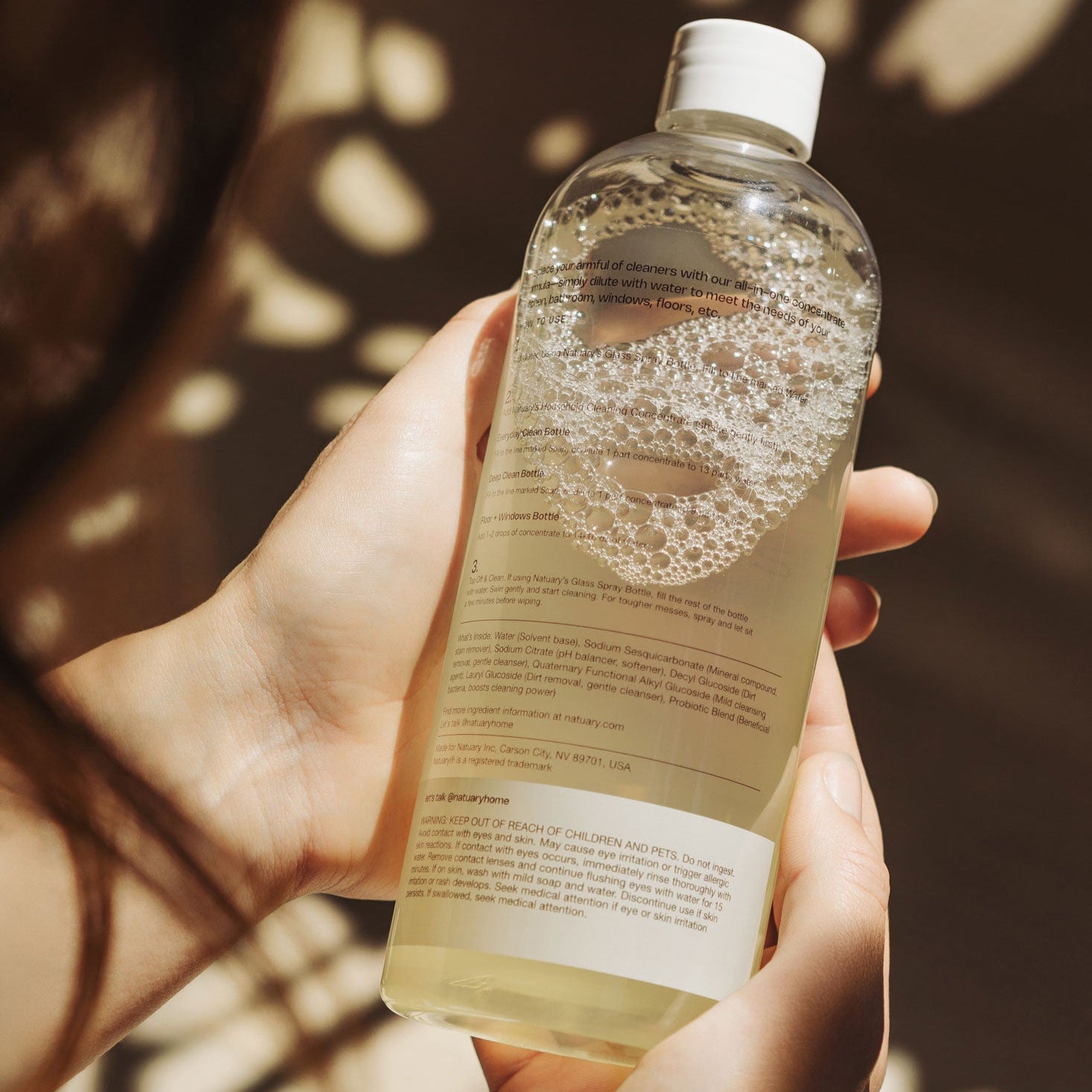 hands holding bottle
